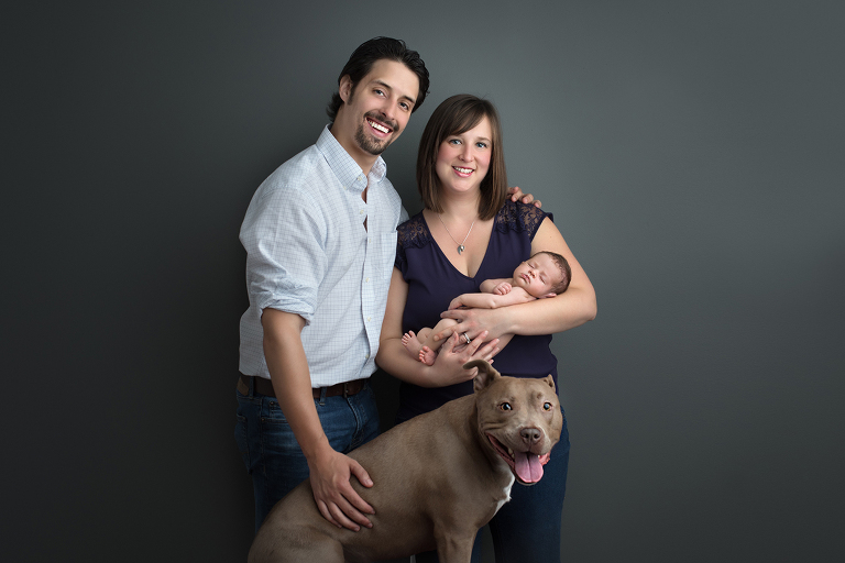 Portrait studio session of family with pet dog and newborn